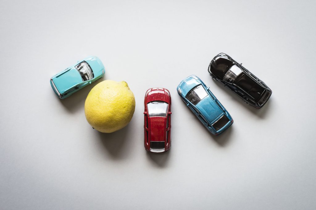 Aerial view of toys cars and a lemon in circle